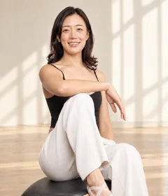 Sienna Kim, lead instructor and founder, seated in the studio